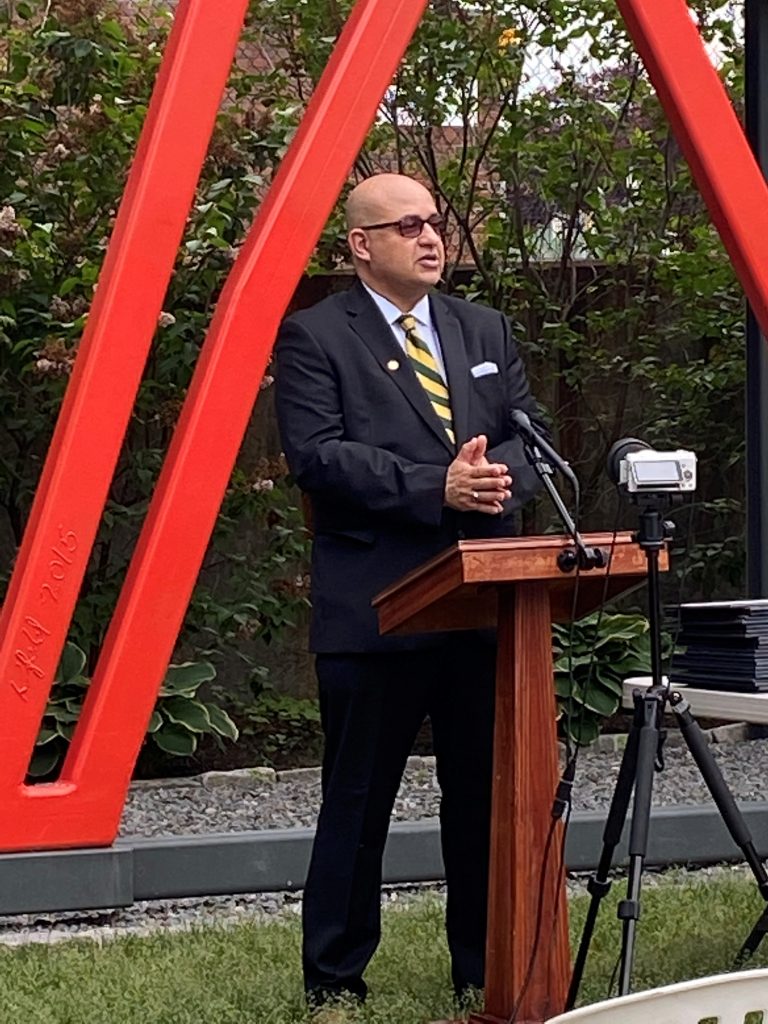 a man in a suit at a wooden podium