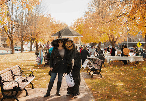 2 adults in Halloween costumes